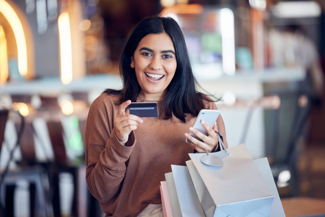 Young professional learning online and managing insurance on her smartphone